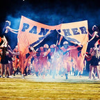 football team entrance with banner
