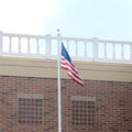 flag on pole against brick wall