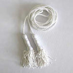 white rope with tassels lying flat