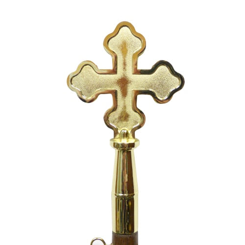 gold cross on wooden handle