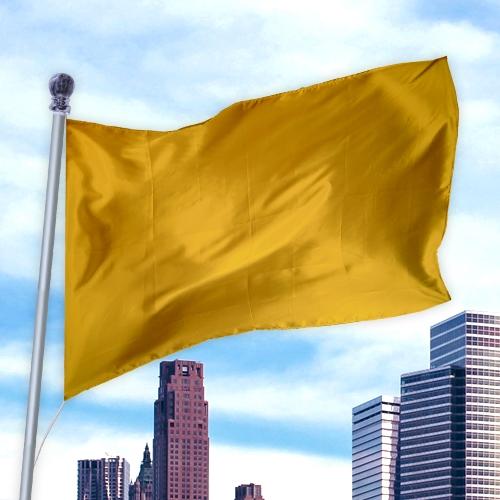 Yellow flag waving on a pole above a city skyline with skyscrapers, made of durable fabric Solid Colored Flags - Premier Nylon
