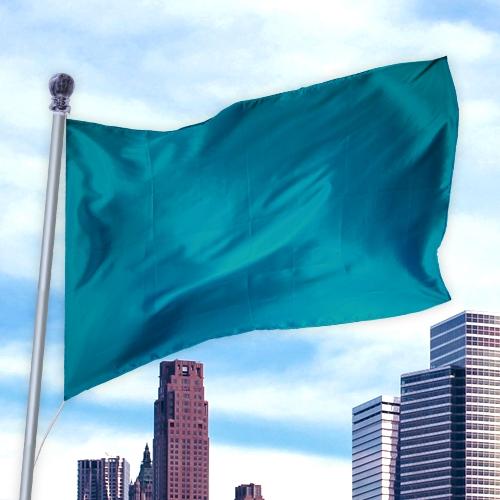 Solid Colored Flags - Premier Nylon flag in teal flying on a pole with city skyline and blue sky background.