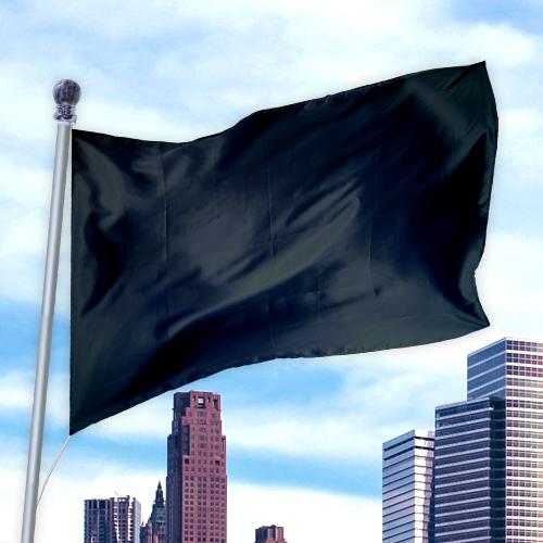 Black solid colored flag made of durable nylon fabric waving on a flagpole against a city skyline, Solid Colored Flags - Premier Nylon.