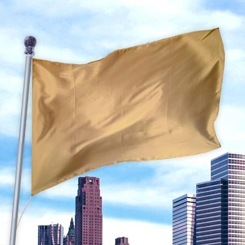 Gold-colored flag made of durable nylon material waving on a pole above a cityscape, Solid Colored Flags - Premier Nylon
