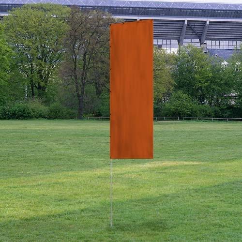 Solid Tall Advertising Flags in a plain orange color displayed outdoors on a grassy field with trees and a stadium in the background.