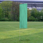 Solid Tall Advertising Flags displayed outdoors on a grassy field with trees and a stadium structure in the background.
