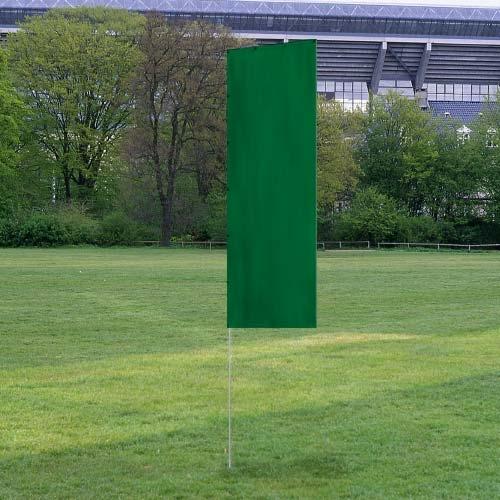 Solid Tall Advertising Flags with a tall, solid green fabric mounted outdoors on a thin pole in a grassy area with trees and a stadium background.