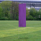 Solid Tall Advertising Flags standing upright on a green lawn with a purple fabric design and trees in the background.