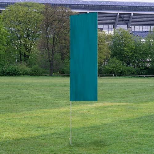Solid Tall Advertising Flags standing upright on a grassy field with trees and a stadium in the background, showcasing a plain solid teal design.