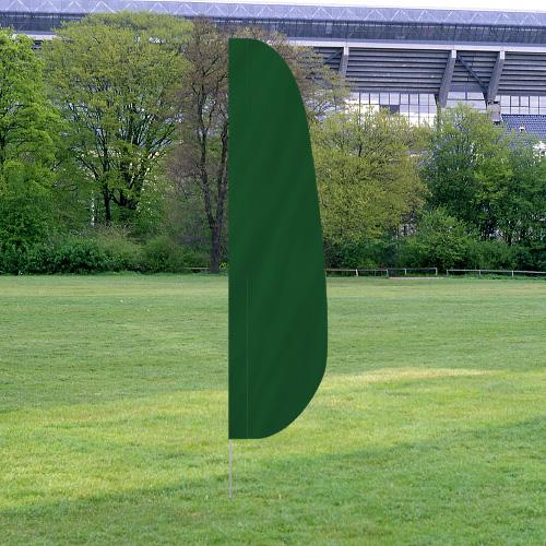 Solid Color Feather Flags in dark green set up outdoors on a grassy area with trees and a stadium in the background.