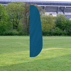Solid Color Feather Flags in turquoise standing outdoors on grass with trees and a stadium in the background.