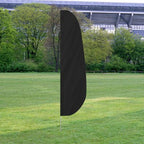Solid Color Feather Flags in black displayed outdoors on a grassy field with trees and a stadium in the background.