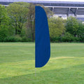 Solid Color Feather Flags in solid blue standing on a grassy field with trees and stadium in the background.