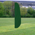 Solid Color Feather Flags displayed outdoors on a grassy field with trees and a stadium in the background, featuring a green flag.