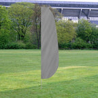 Solid Color Feather Flags displayed outdoors on a grassy area with trees and a stadium in the background.