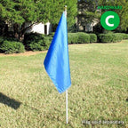 blue flag on white pole in grass