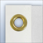 brass grommet on white fabric