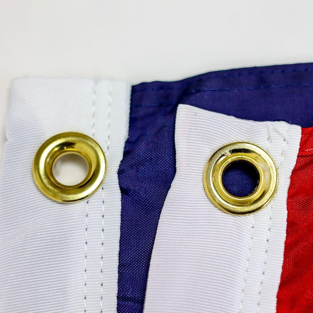 Flag grommets with reinforced edge