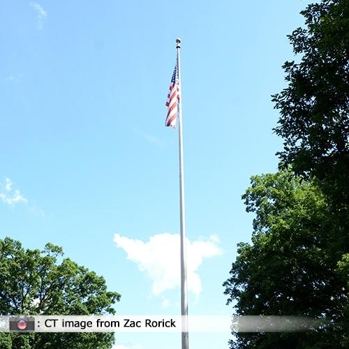 American flag on flagpole sunny day
