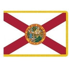 Indoor Florida state flag with red cross, state seal, and gold fringe