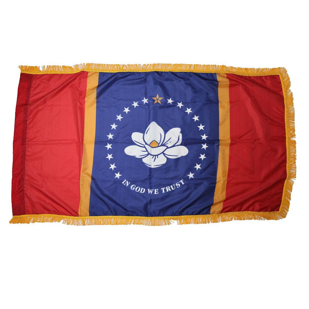 Indoor Mississippi state flag with magnolia emblem, stars, and gold fringe