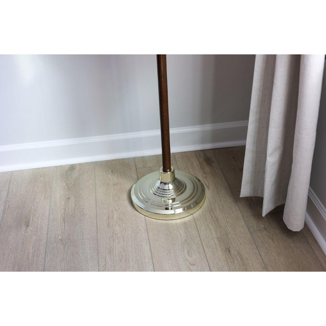 Indoor flagpole base with gold finish and wooden pole on floor