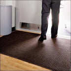 man standing on rug by doorway