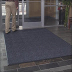 person standing on entrance mat